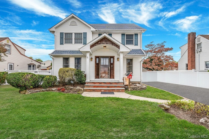 View of front of property with a shingled roof
