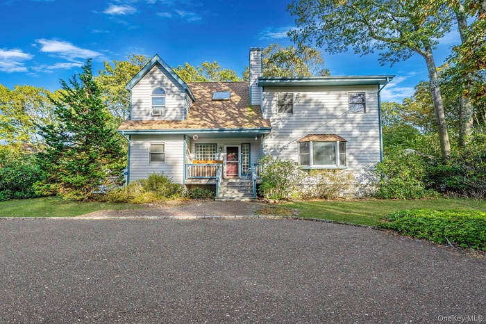 View of front of home with covered porch and a chimney