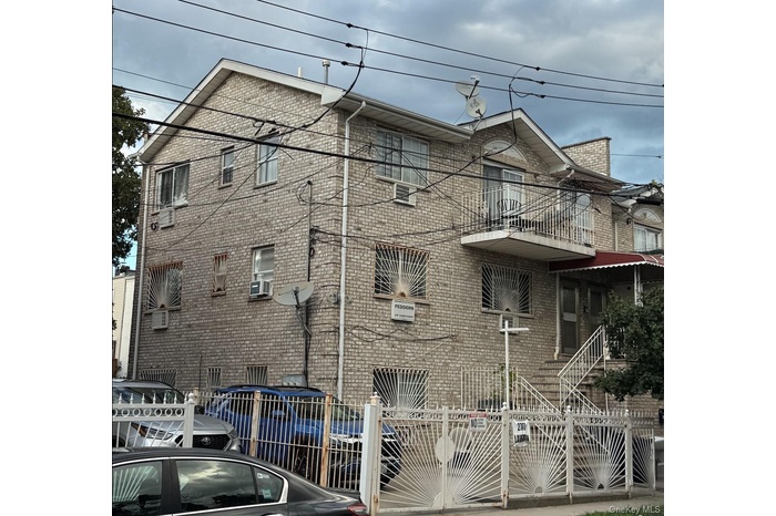 View of side of property featuring a balcony and brick siding