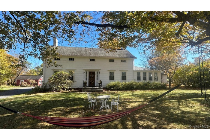 View of front facade with a chimney and a front yard