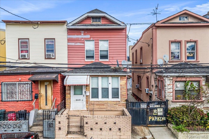 View of front of house featuring a fenced front yard and a gate