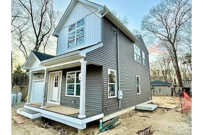 Rear view of house featuring covered porch