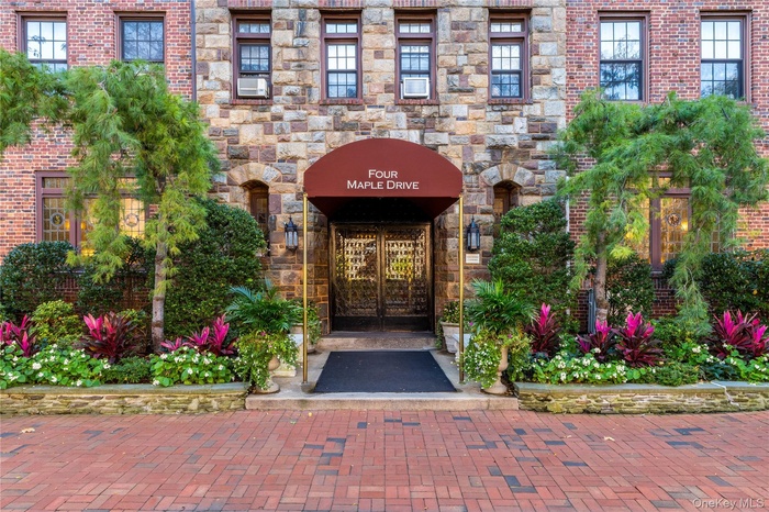 View of exterior entry with brick siding, french doors, and stone siding