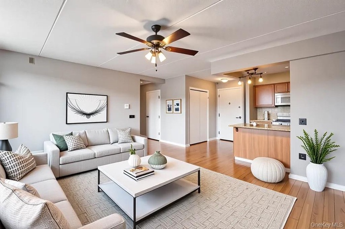 Virtual Staging: Living area featuring light wood-style floors and a ceiling fan