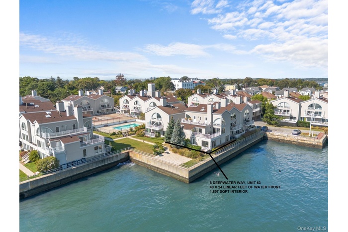 Aerial view of residential area featuring a nearby body of water