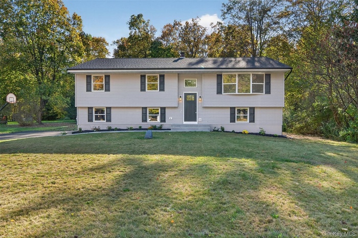 Raised ranch featuring a front lawn