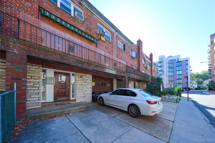 View of building exterior featuring driveway and a garage