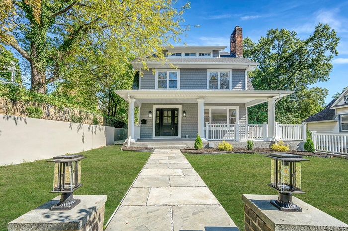 Traditional style home featuring a porch and a chimney