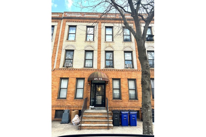 Townhome / multi-family property featuring brick siding