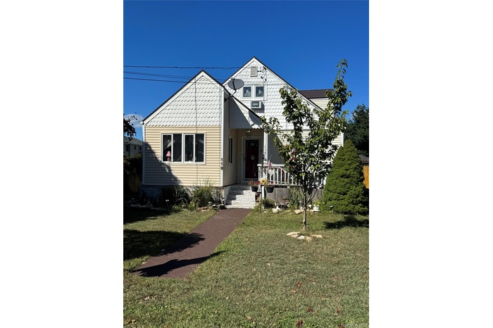 View of front of property with a front lawn
