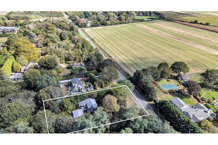 View of property location with property boundaries highlighted and a tree filled landscape