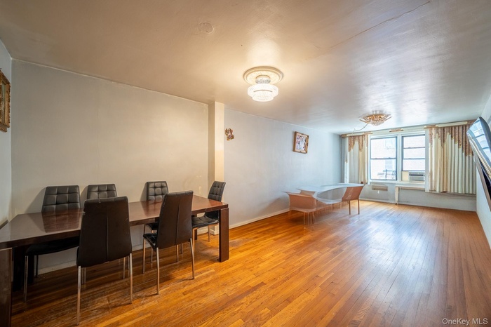 Dining area with wood-type flooring and baseboards