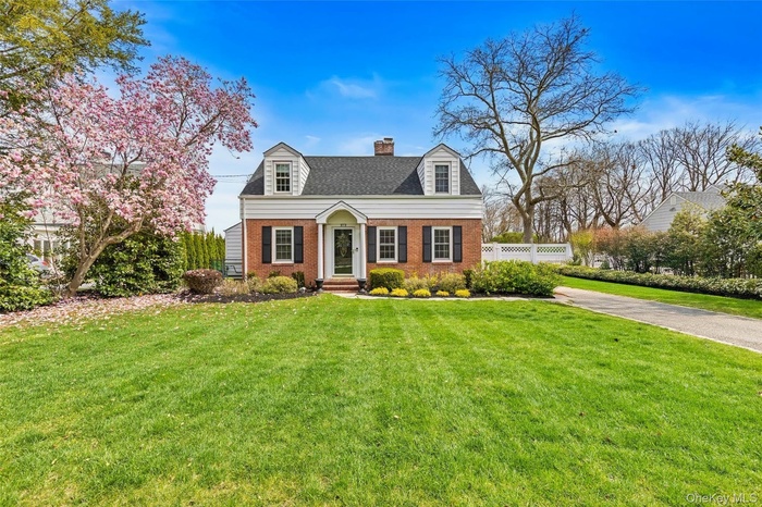 Front of Home with long driveway that extends past fencing