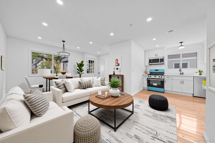 Living area featuring light wood finished floors and recessed lighting