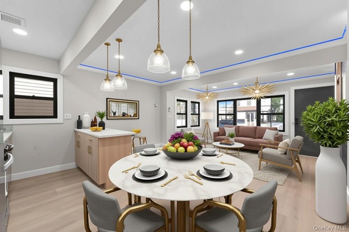 Dining room featuring light wood finished floors and recessed lighting