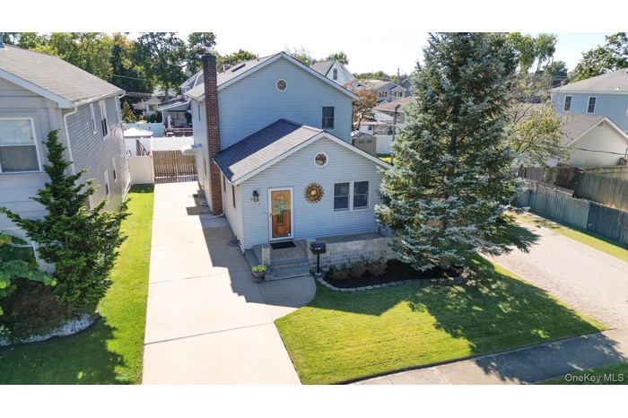 View of front of home featuring a chimney and a residential view