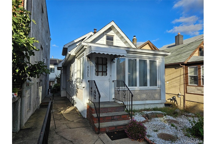 View of front of house featuring a sunroom