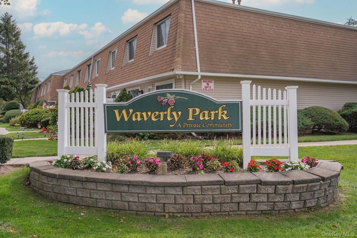 Community / neighborhood sign featuring a yard