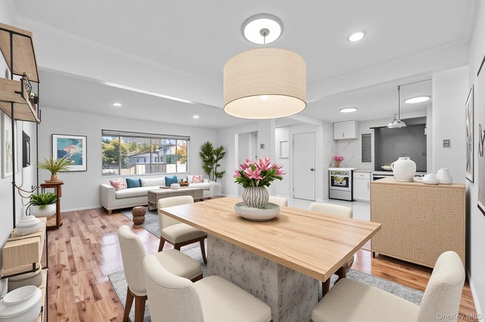 Dining area featuring light wood-type flooring and recessed lighting
