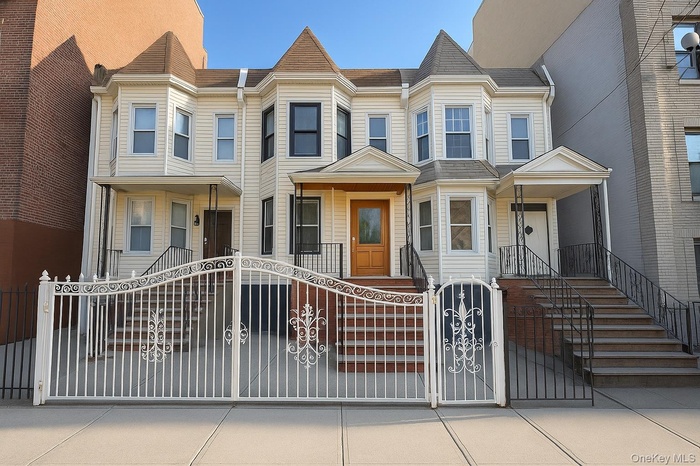 Victorian-style house with a gate and a residential view