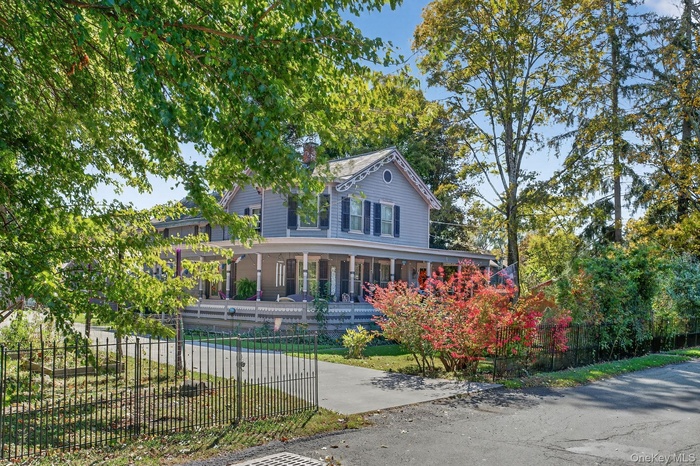 View of front of house with a porch and a fenced front yard