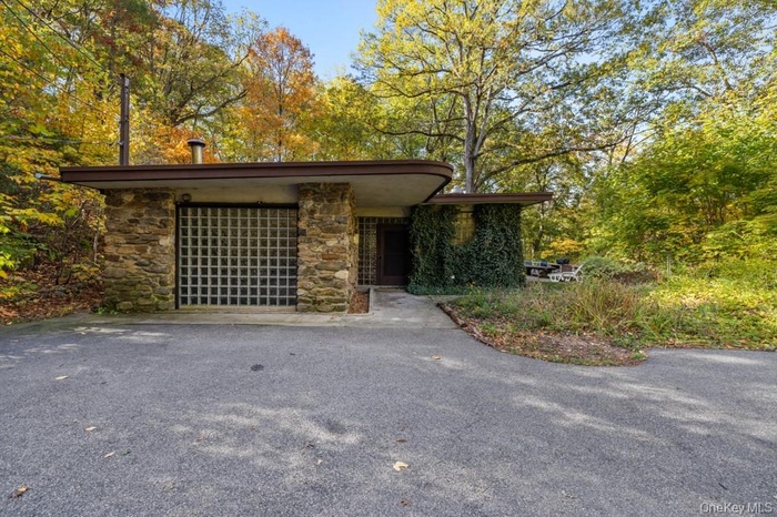 View of front of home with stone siding and Block Glass
