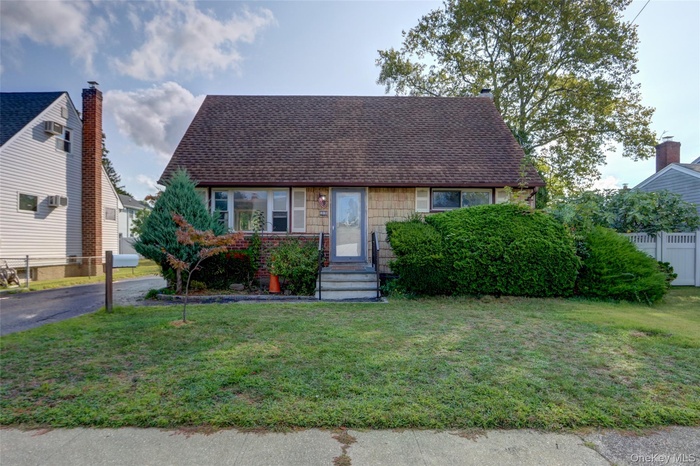 View of front of home featuring roof with shingles