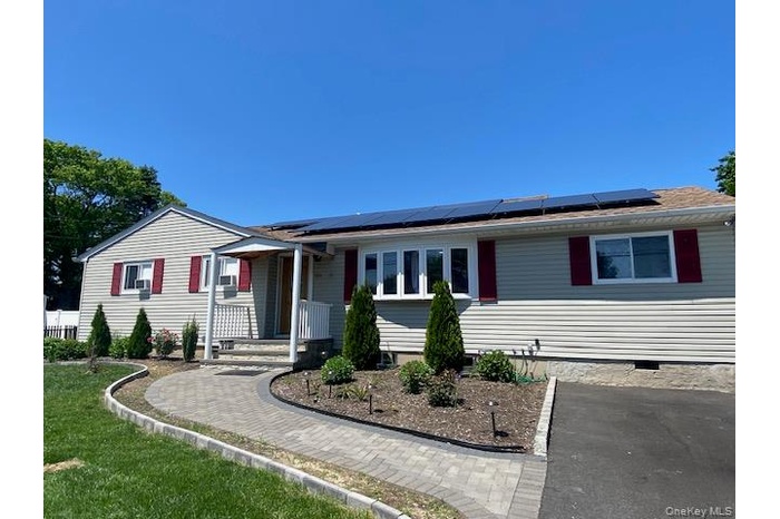 Ranch-style home featuring roof mounted solar panels and crawl space