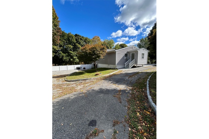 View of property exterior featuring crawl space, entry steps, and driveway