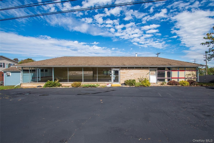 View of front of property with a shingled roof