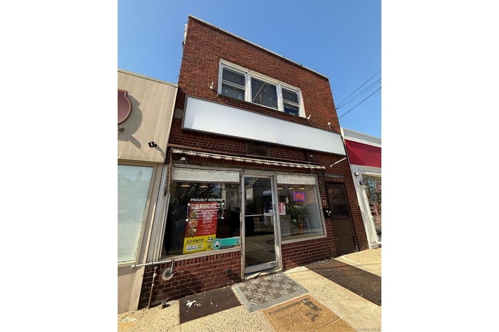 Property entrance featuring brick siding