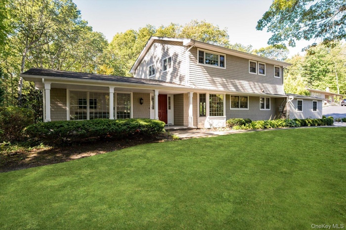View of front of property featuring a porch and a front lawn