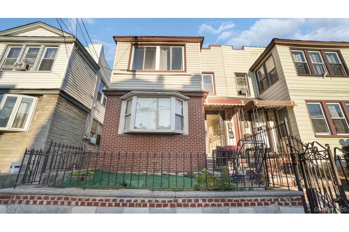 View of front of house with a fenced front yard and brick siding
