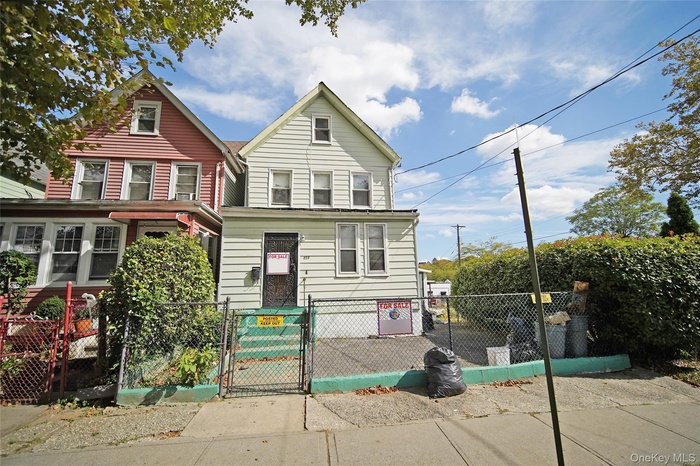 View of front of property with a gate and a fenced front yard