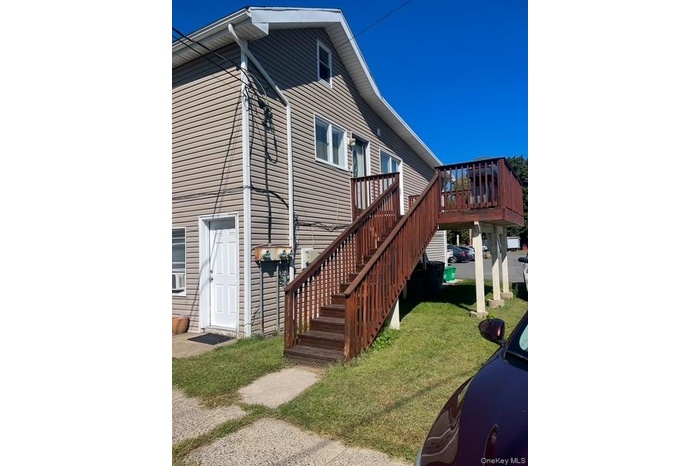 Stairs lead to the entry door on deck
