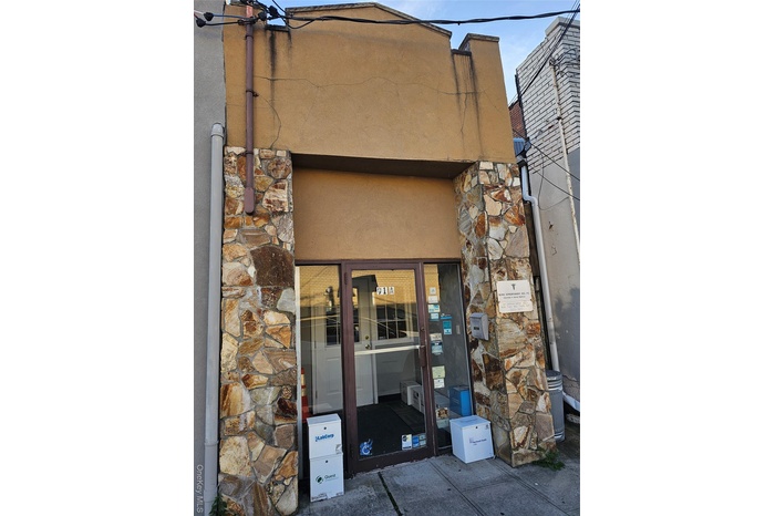 Doorway to property with stone siding and stucco siding