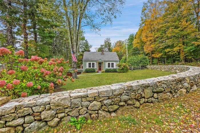 Incredible curb appeal, stone wall, mature landscaping