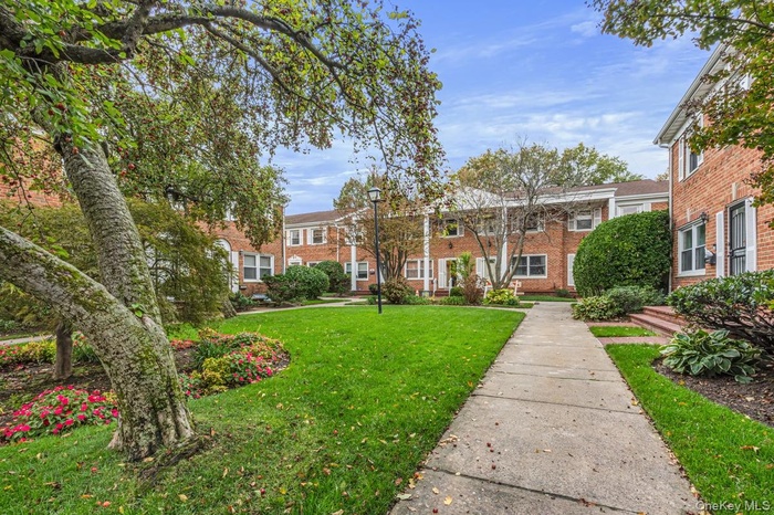 View of front of house featuring brick siding and a front lawn