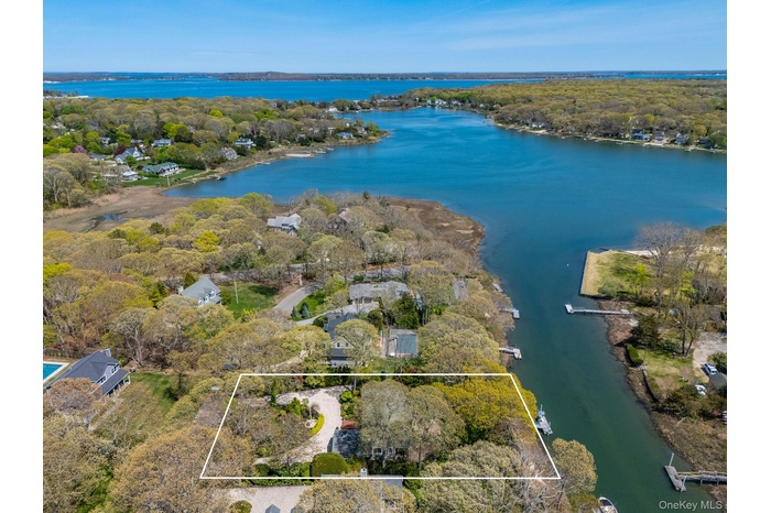 View of property location with a large body of water and property boundaries highlighted