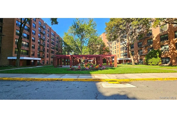 View of property's community featuring a pergola and a lawn