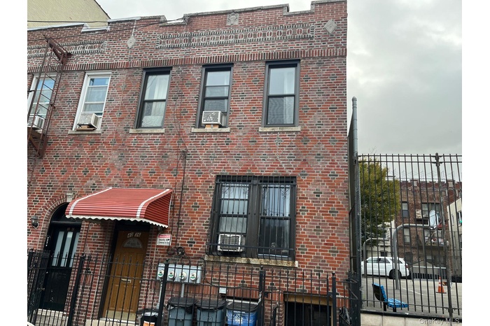 View of building exterior featuring a fenced front yard