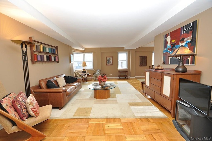 The bright and sunny living room opens to both the dining area and entry foyer.  There are parquet floors and the room is 21'-5" x 14'-5".