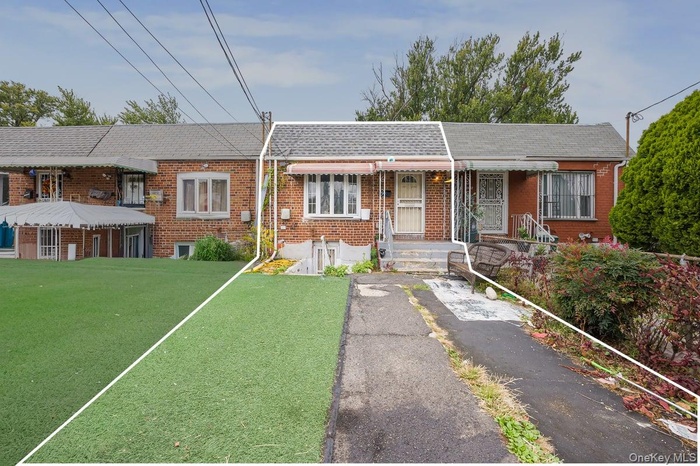 View of front of house with brick siding and a shingled roof