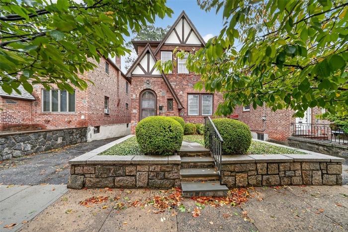 Tudor house featuring brick siding and stucco siding