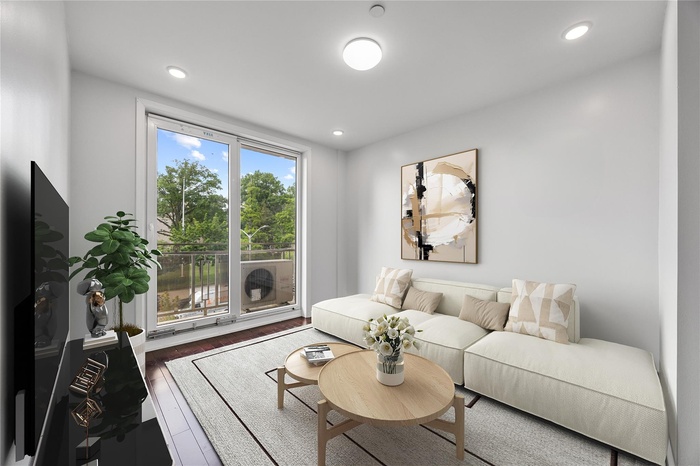 Living area featuring wood finished floors and recessed lighting
