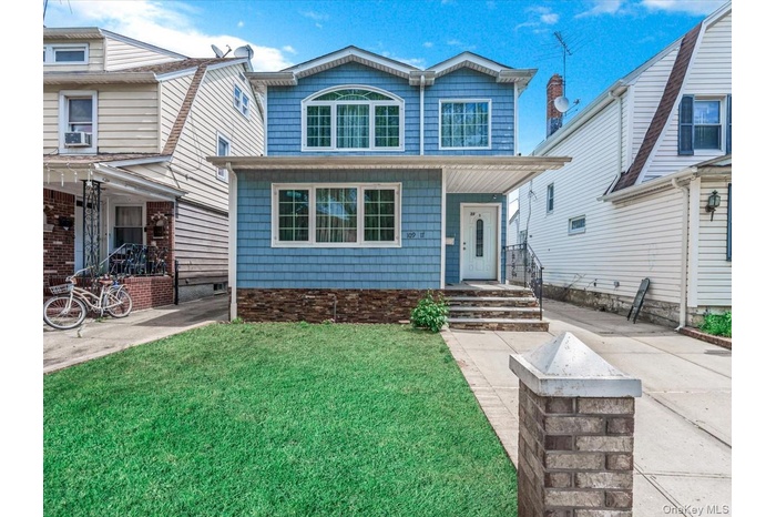 View of front of property with a front lawn