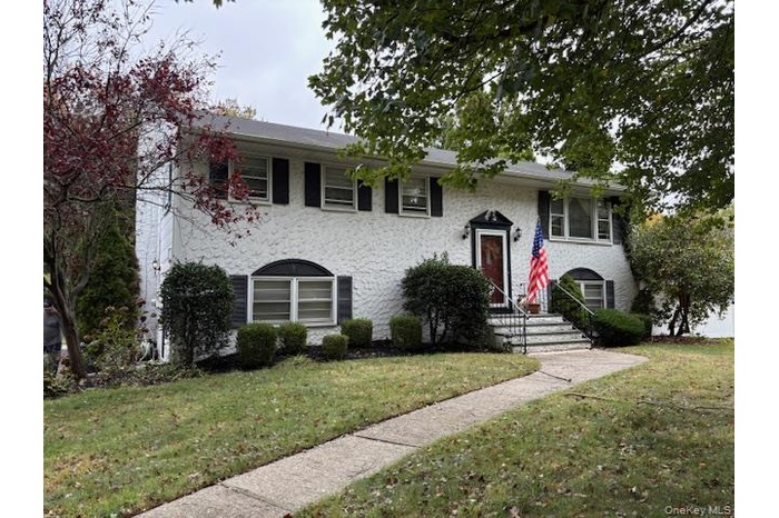 View of front of property with a front lawn