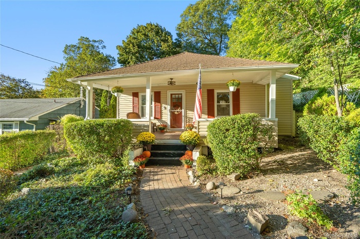 Bungalow-style house with a porch and a shingled roof