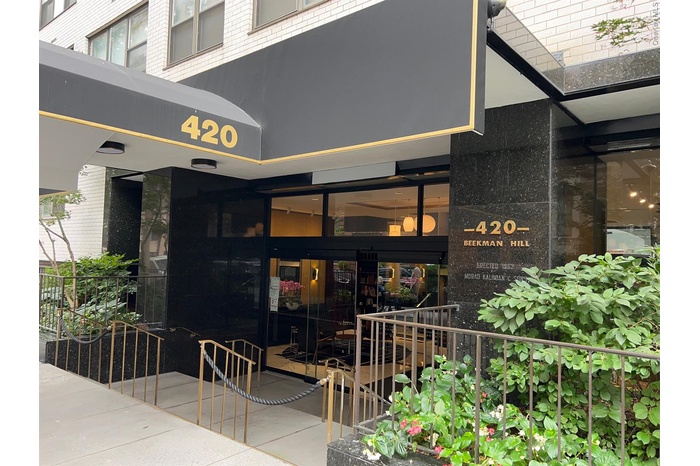 Property entrance featuring brick siding