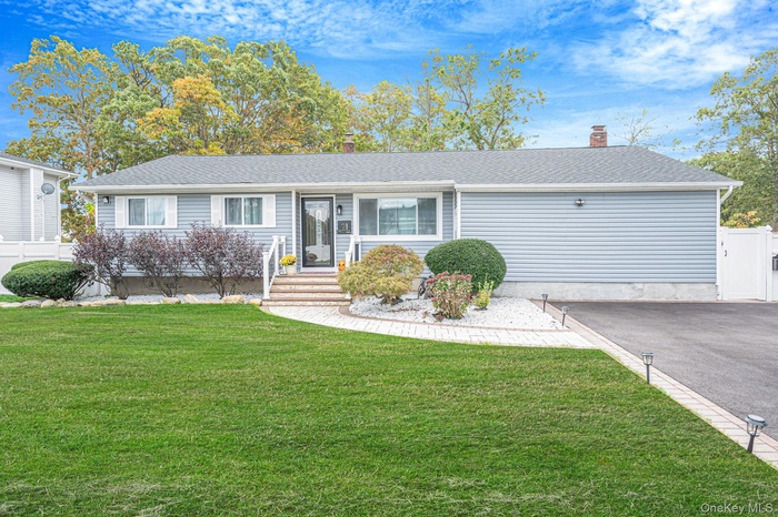 Ranch-style house with a chimney and roof with shingles